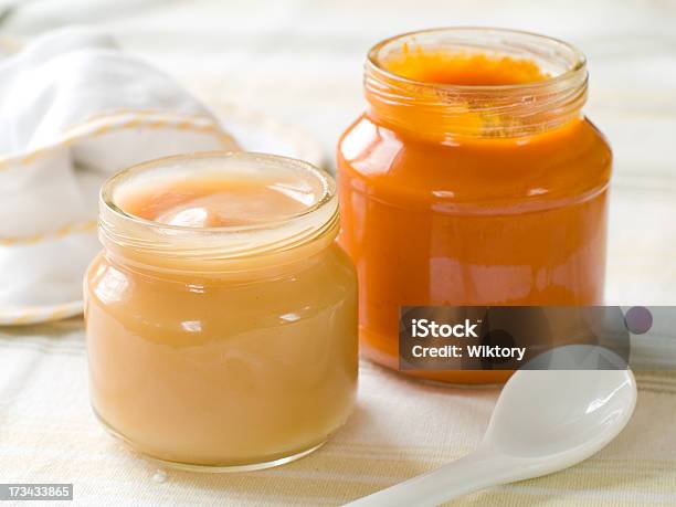 Two Open Jars Of Baby Food With A Spoon In The Foreground Stock Photo - Download Image Now