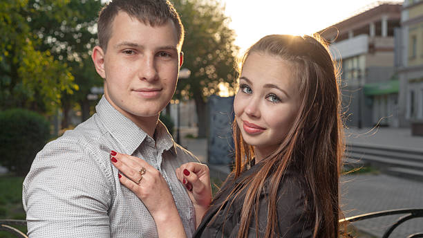 istock romantic young couple relaxing on grass 173436762