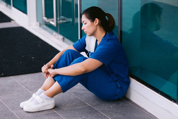 istock Stressed tired healthcare worker sitting on floor 1734385538