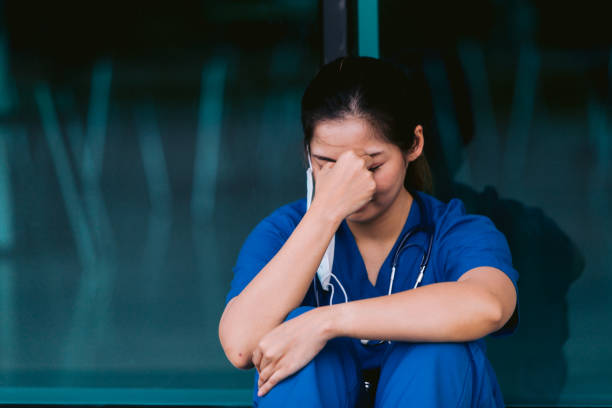 istock Stressed tired healthcare worker sitting on floor 1734385545