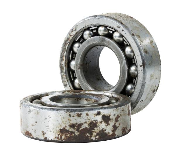Bearing on a white background. Old worn bearing covered with rust