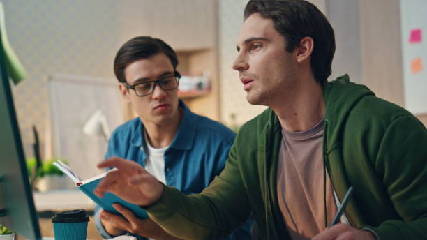 istock Two men brainstorming computer at business place closeup. Teamwork cooperation 1734408129