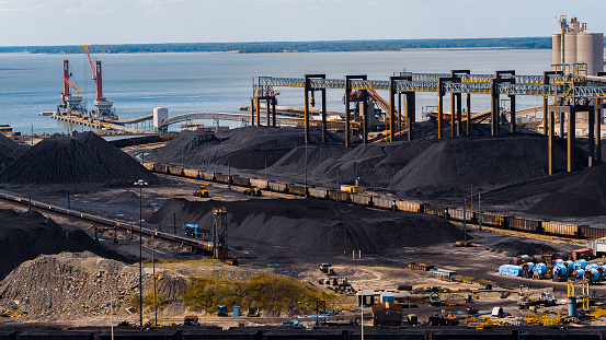 Coal trading industry in Virginia. Wet coal heaps help to avoid dust spreading and air pollution in Newport News, VA