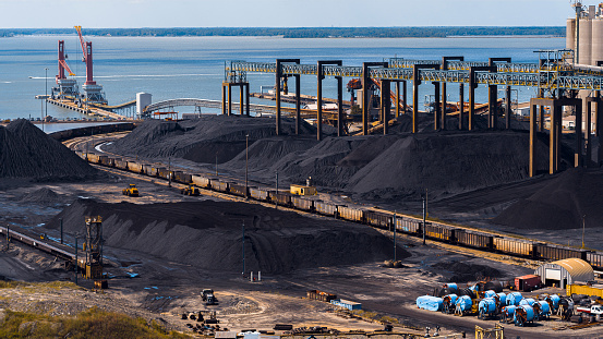 Virginia coal transit and port management. Wet coal heaps along the beltway in Newport News Port, VA.