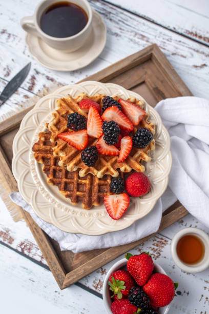 istock Protein healthy waffles, with berries, on a cream plate for breakfast 1734455920