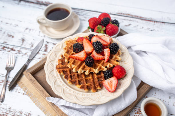 istock Protein healthy waffles, with berries, on a cream plate for breakfast 1734456447