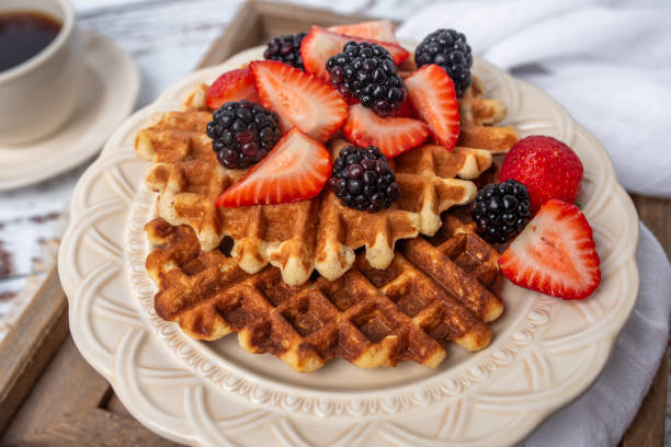 istock Protein healthy waffles, with berries, on a cream plate for breakfast 1734457063