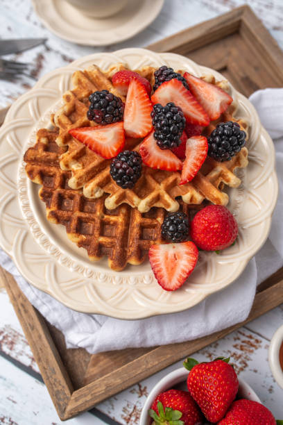 istock Protein healthy waffles, with berries, on a cream plate for breakfast 1734457465