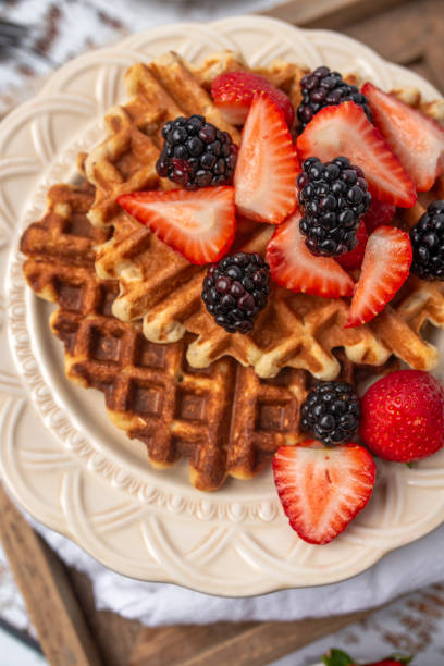 istock Protein healthy waffles, with berries, on a cream plate for breakfast 1734457645