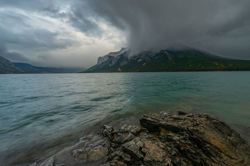 Storm clouds gathering over Lake Minnewanka, Banff National Park, Alberta, Canada.