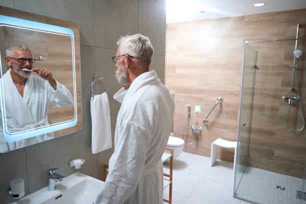 istock Cheerful old man brushes his teeth in the bathroom 1734472088