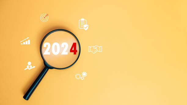 istock Magnifying glass focused on letter 2024 on yellow background. Represents setting goals for 2024, Startup concept. Financial planning, development, Business strategy, Setting business goals. 1734499363