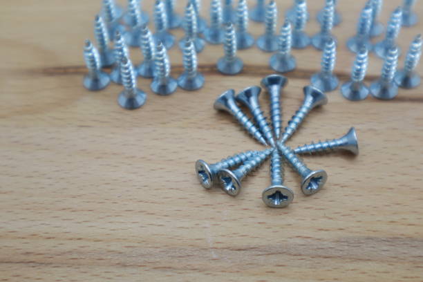 istock screws arranged on wooden background close-up view 1734532642
