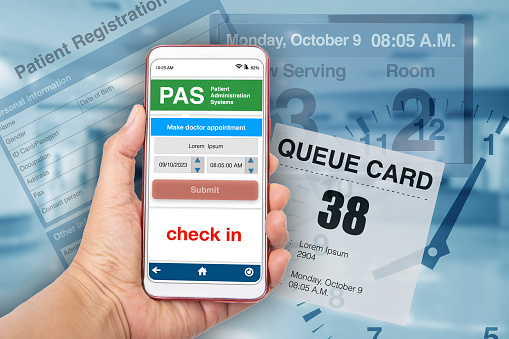 Hand holding smartphont showing electronic queueing application for patient who waiting for medical treatment.