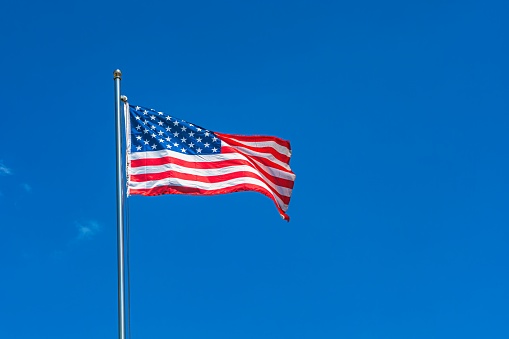 Flag of USA on light grey wooden background.\nEmpty space provided for text placement for US celebrations such as: Memorial Day, Independence Day, etc.