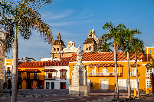 View to a plaza with a statue, historical buildings, church towers and palm trees, Cartagena, Unesco World Heritage