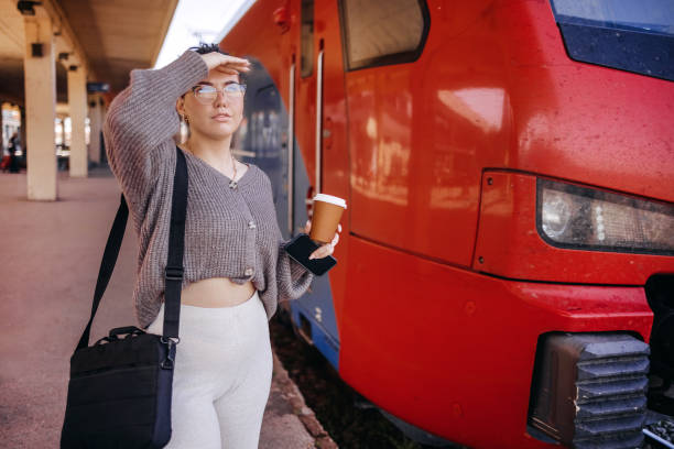 istock Young woman waiting for train on the way to work 1734809189
