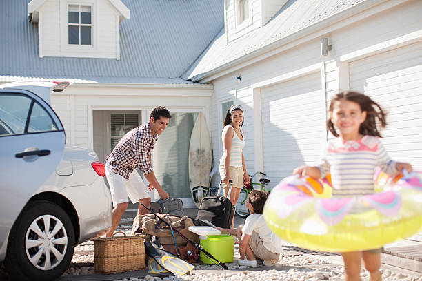 Girl with inflatable ring running in driveway  hopper car stock pictures, royalty-free photos & images