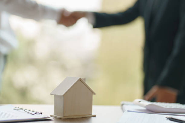 istock Sales manager giving advice application form document, considering mortgage loan offer for car and house insurance. Real estate investment Property insurance and security. Real estate agent offer house. 1734829411