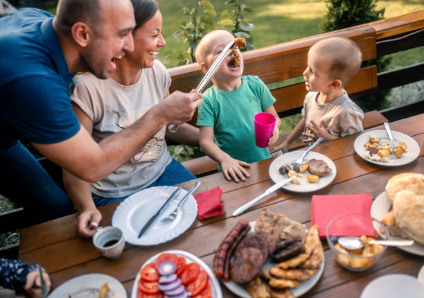 istock the family makes a barbecue in the yard and eats at the table 1734832343