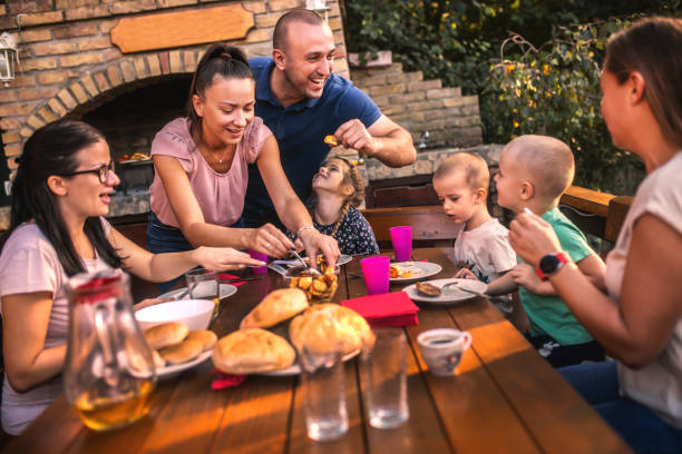 istock the family makes a barbecue in the yard and eats at the table 1734835608