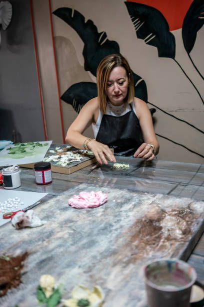 istock women relief artist is working in studio relief is on canvas vertical art still 1734842324