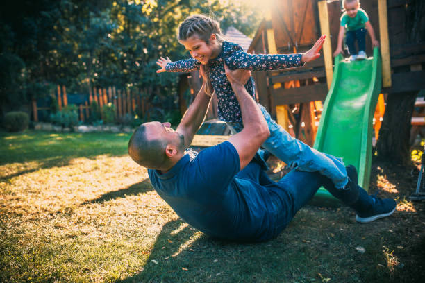 istock children play with their parents in the back yard 1734846840