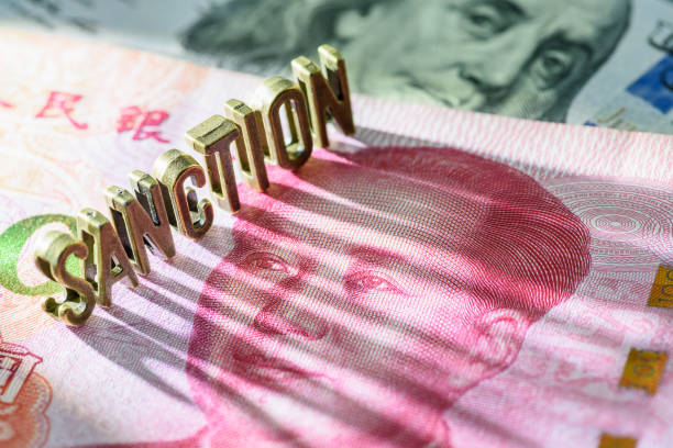 Word SANCTION on Chinese yuan note. US has imposed sanctions on China due to trade tensions, human rights concerns, and national security issues, influencing global diplomatic and economic dynamics. palabra sanciÓn en el billete de yuan chino. estados unidos ha impuesto sanciones a china debido a las tensiones comerciales, las preocupaciones sobre los derechos humanos y los problemas de seguridad nacional, lo que ha influido en la dinámica diplomát