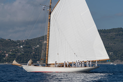 Imperia, Italy - September 7, 2018: Crew members aboard on sailboat the old style, during regatta in Gulf of Imperia. Established in 1986, the Imperia Vintage Yacht Challenge Stage is a of the most important event in sailing the Mediterranean dedicated to historical boats