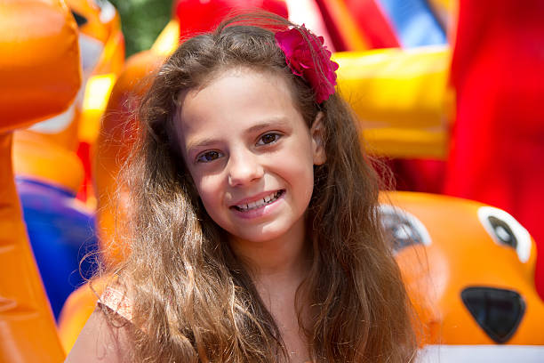 istock Cute little girl plays in bouncing castle 173489030