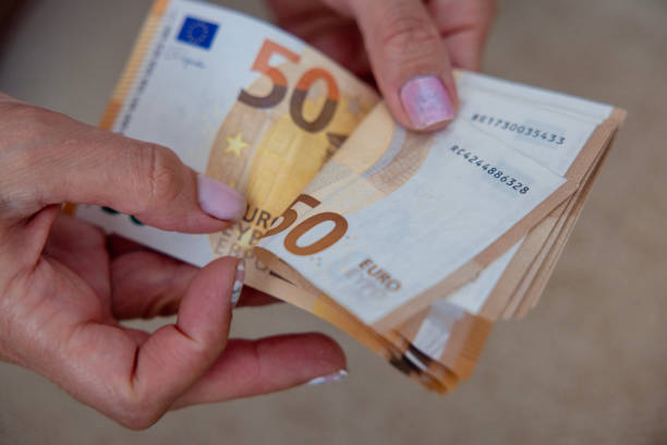 Woman hands hold and counting euro banknotes