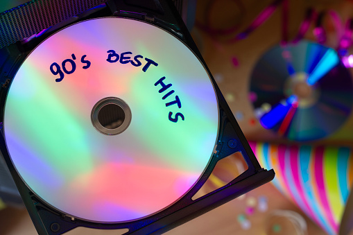 CD with music from 90s, disco party lights, party concept to 90s music