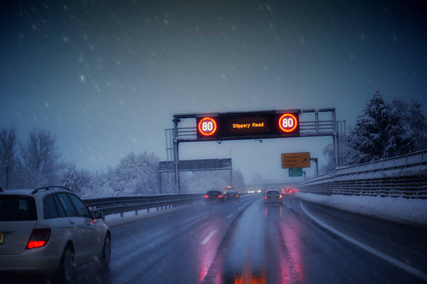 Driving in a highway during a snowstorm. Slippery road condition. 