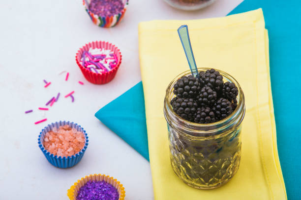 black berries in mason jar and  colored sugar
