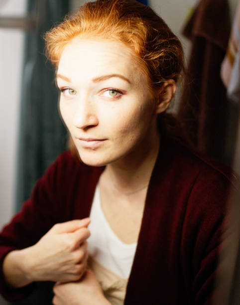 pretty woman near the window hiding with a blanket fun weekend vacation. High quality photo