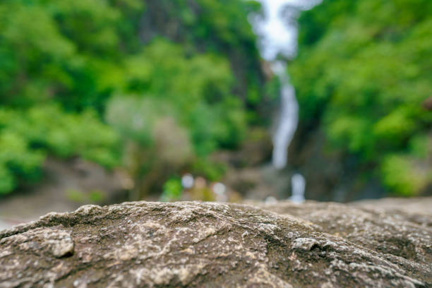 istock Empty surface of stone on the background of waterfall and jungle 1734953703