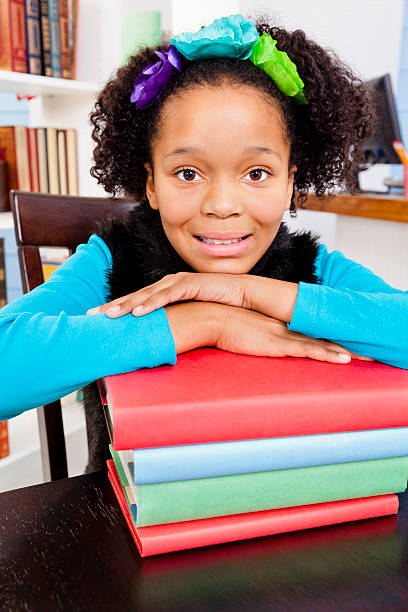istock African descent student in library with books.  Smiling at camera. 173498231