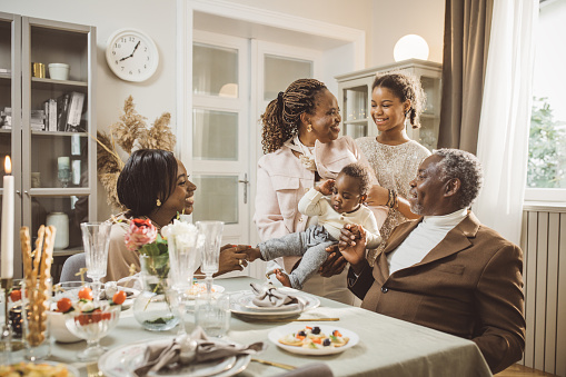 Happy extended family talking during dinner.