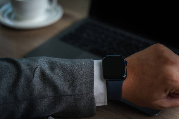 istock Man checking time on his smartwatch device Close-up display clock checking lifestyle communication phone mobile touch app technology 1734982576