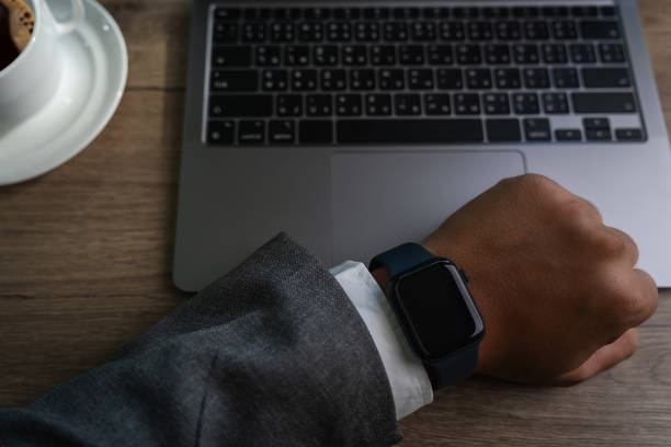 istock Man checking time on his smartwatch device Close-up display clock checking lifestyle communication phone mobile touch app technology 1734982592