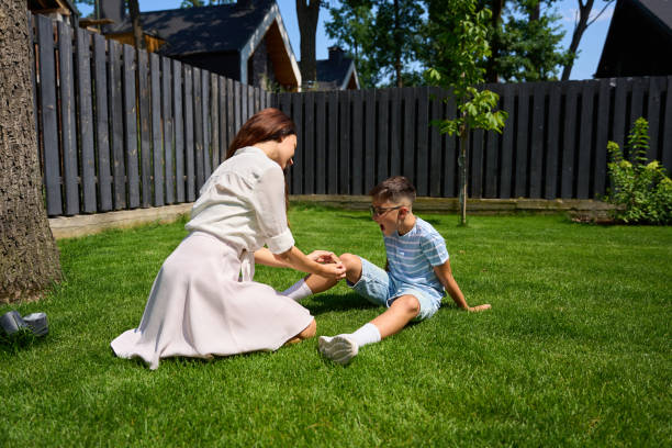 istock Smiling mother consoles her son on the green lawn 1734997111