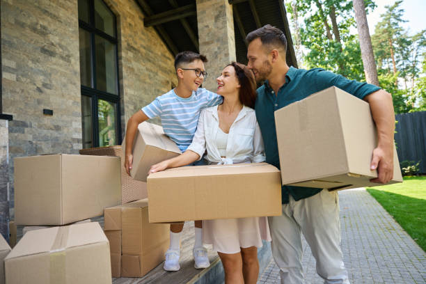 istock Young parents and their son move boxes of things 1734997158