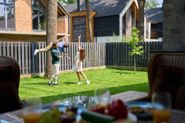 istock Dad, mom and son are playing happily on front lawn 1734997737