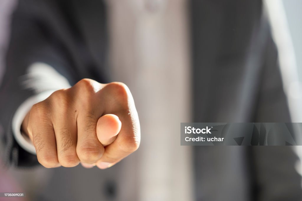 Businessman in a suit shows a fig sign Office Stock Photo