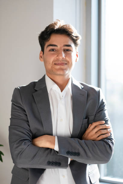 istock Successful young man with arms crossed looking at camera 1735010274