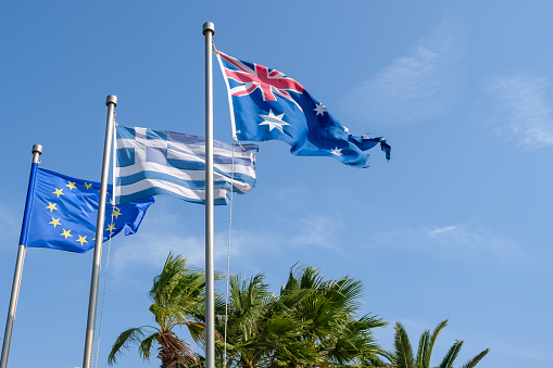 View of the Australian national flag, the Greek national flag and the flag of the European community