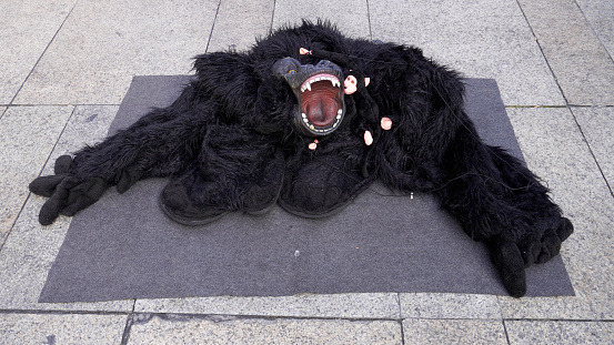 huge monkey suit, black. lies on the asphalt