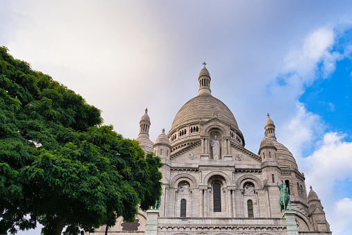 Front view of the Basilica of the Sacred Heart of Paris (Basilica Sacred Coeur) at the top of Montmartre hill in Paris, France. It is the second place most visited by tourists in Paris.