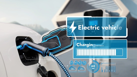 Electric car recharging from EV charging station display smart digital battery status hologram. Technological advancement of rechargeable EV car using alternative and sustainable energy. Peruse