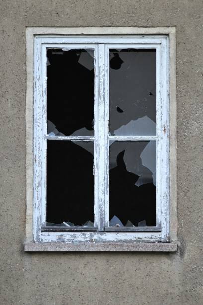 istock smashed window of an abandoned building 1735060023